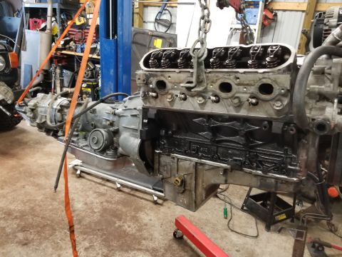 1991 Mitsubishi Montero - Engine and transmission assembly being worked on in a garage setting, with tools and equipment visible in the background.