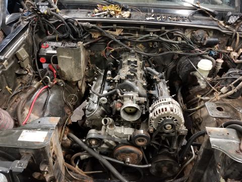 1991 Mitsubishi Montero - The engine bay is mostly empty, with the engine itself removed for work or replacement.