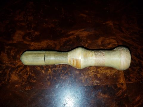 2018 Ford Bronco - A wooden tool, possibly a pestle or rolling pin, rests on a dark, polished wooden surface.