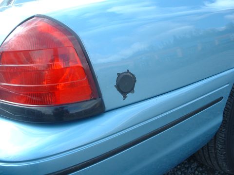 1999 Ford Crown Victoria - Hole in the rear panel pluged where a spare key used to be put. All Seattle police vehicles have this.