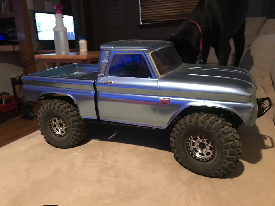 Metallic blue RC pickup truck with large off-road tires, chrome trim, and a red "10" badge.