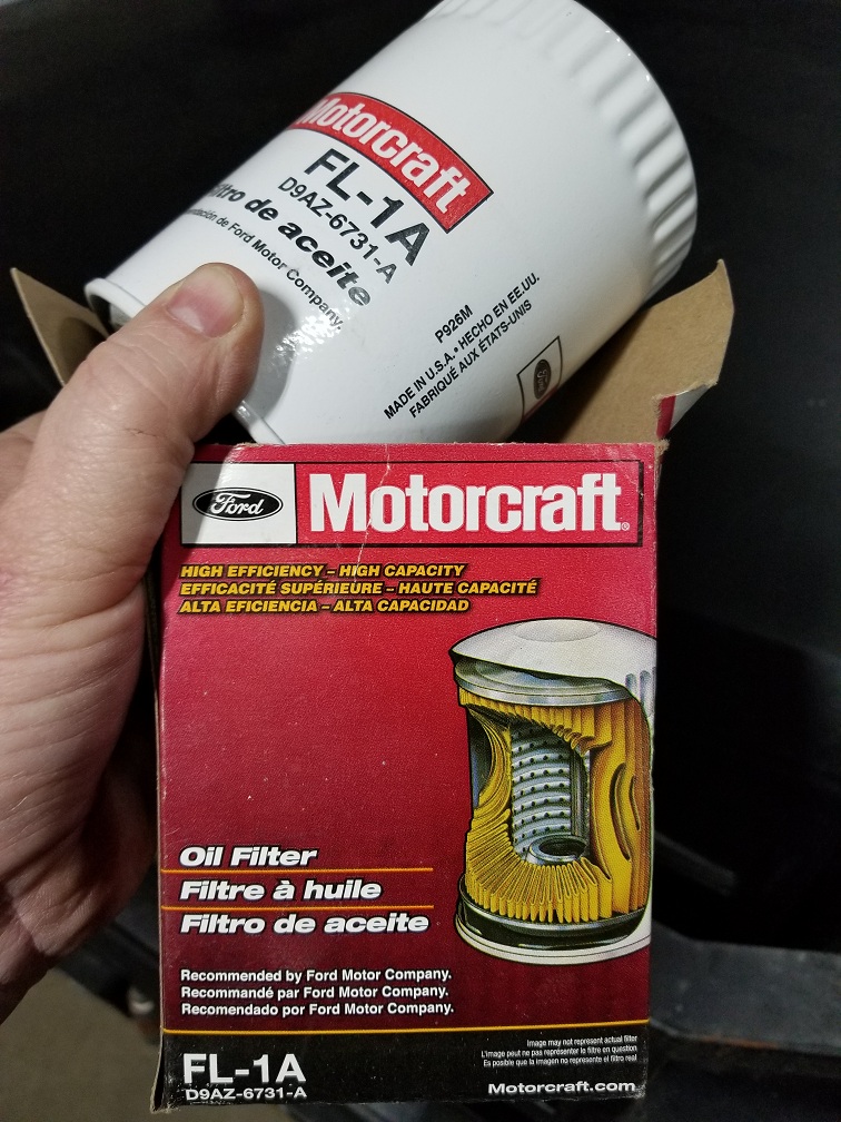 White Motorcraft FL-1A oil filter held beside its red retail box