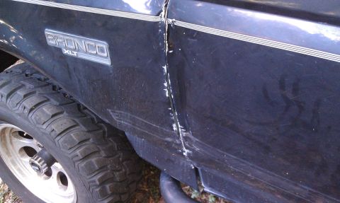 1995 Ford Bronco - Dented door and fender