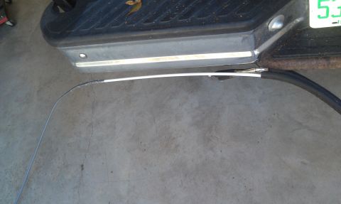 1995 Ford Bronco - A detached cable lies on the ground near the rear bumper of a vehicle. The "SuperMotors.net" watermark is visible.