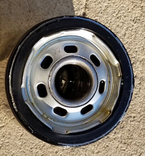 2000 Ford Crown Victoria - An oil filter is shown with a black rubber gasket and a metal threaded end.