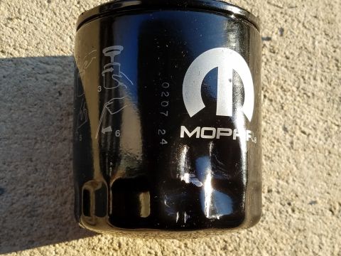 2000 Ford Crown Victoria - Close-up of a Mopar oil filter showing installation diagrams and a date code.