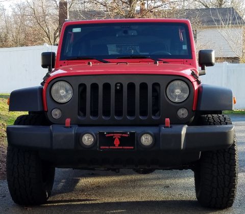 2000 Ford Crown Victoria - This red Jeep Wrangler is shown from the front, a prominent grille and a license plate indicating 'Special Operations Command'.