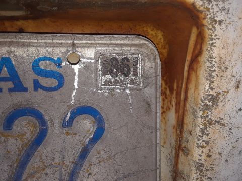 1985 Ford Bronco - Close-up of a license plate showing a 1986 registration sticker and blue lettering.