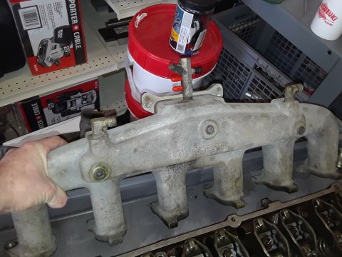 1985 Ford Bronco - Close-up of an intake manifold, part of an engine rebuild.