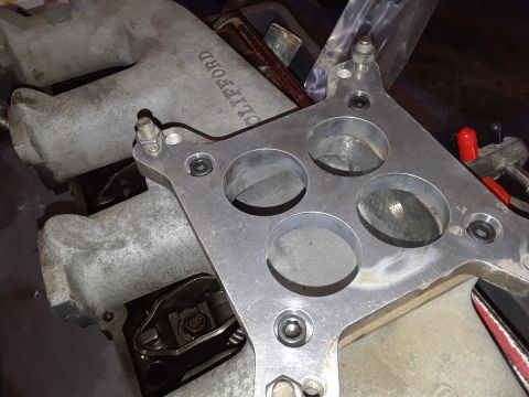 1985 Ford Bronco - Engine intake manifold and carburetor spacer shown during an engine rebuild.