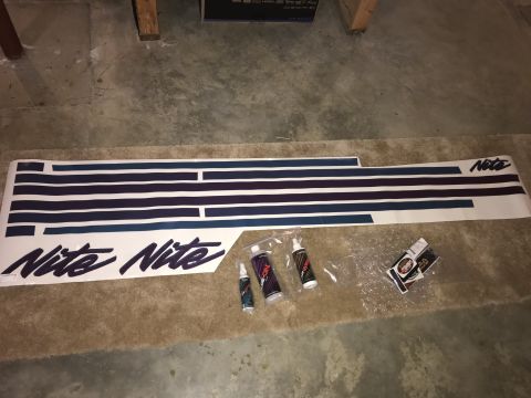 1992 Ford Bronco - A set of Nite decals and application bottles are laid out on a carpeted floor.