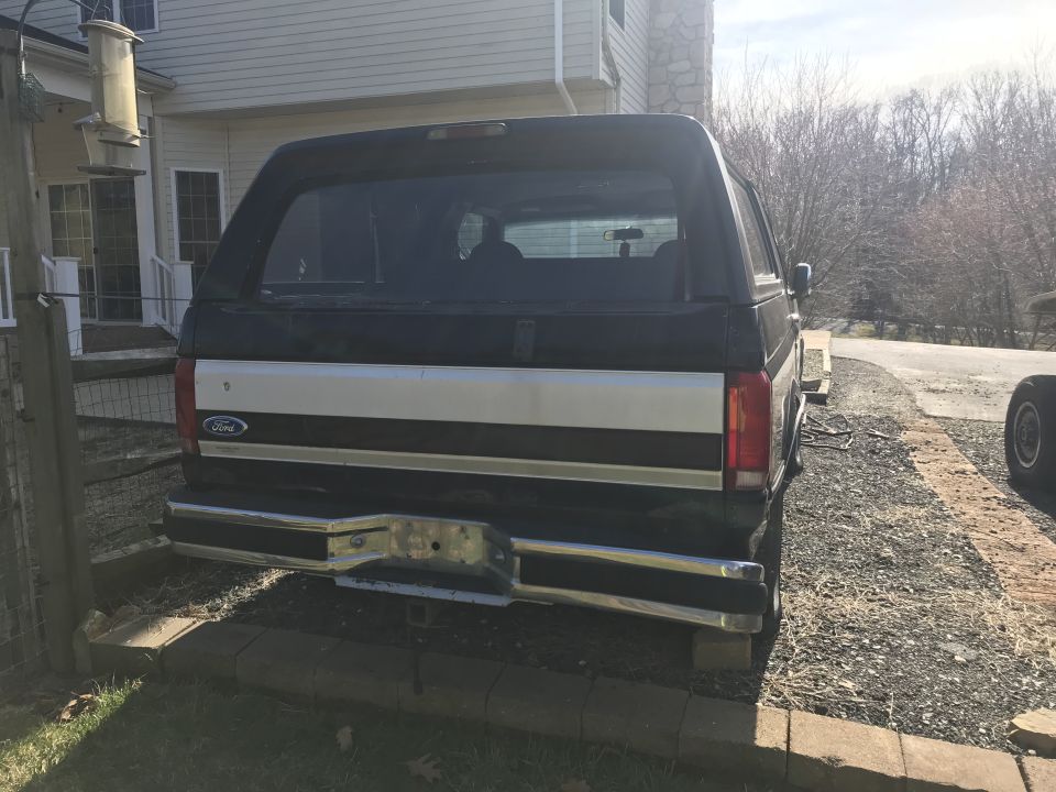 1992 Ford Bronco rear view with black and silver two-tone paint and chrome bumper