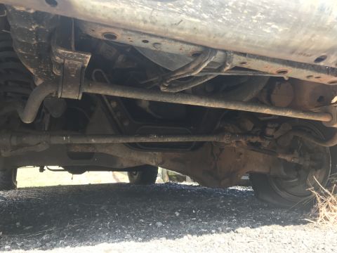 1992 Ford Bronco - Underside view shows suspension and drivetrain parts of an unidentified vehicle.