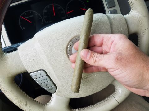 2018 Ford Bronco - Cigar held over the steering wheel of a Lincoln vehicle.