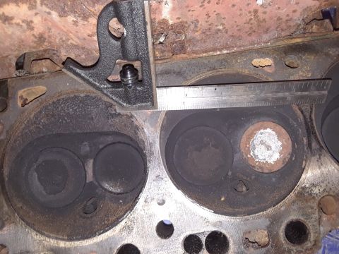 1985 Ford Bronco - Measuring tool on engine cylinder head, likely for valve depth during rebuild.