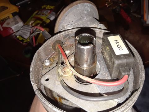 1985 Ford Bronco - Close-up view of a vehicle's distributor cap, showing internal components and wiring.