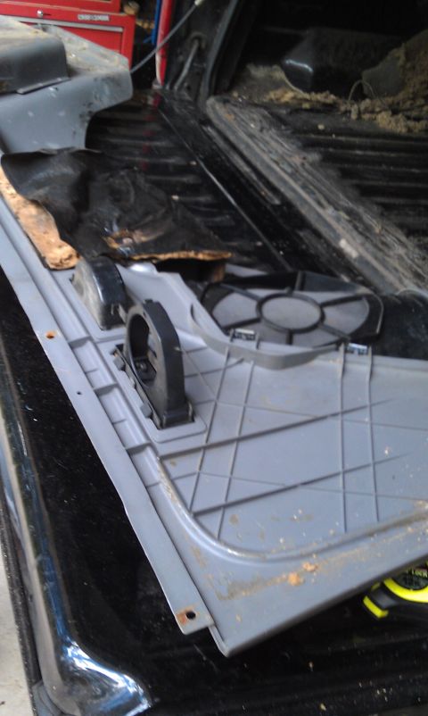 1995 Ford Bronco - The interior trim panel shows signs of wear and tear, with some dirt and rust visible.