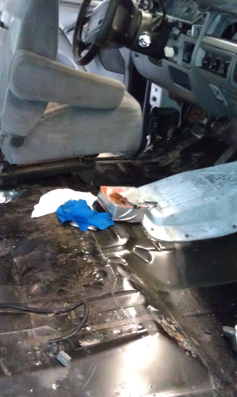 1995 Ford Bronco - The interior of a 1995 Ford Bronco shows worn seats and a dashboard in disarray, suggesting a restoration project.