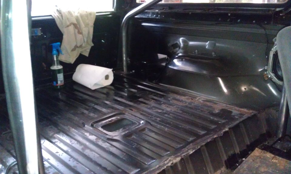 Interior floor of a vehicle with a roll bar, paper towels, and a spray bottle