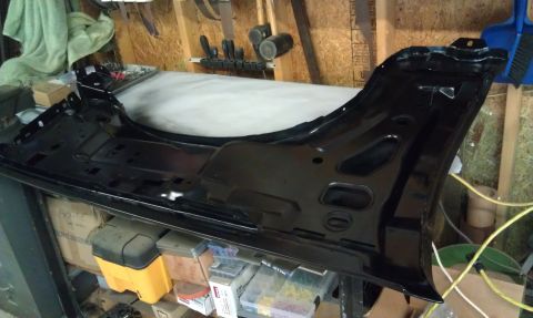 1995 Ford Bronco - A black fender assembly is shown in a workshop setting, likely for a vehicle repair or restoration project.
