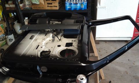 1995 Ford Bronco - The interior of a black car door is shown, revealing its internal components and wiring.
