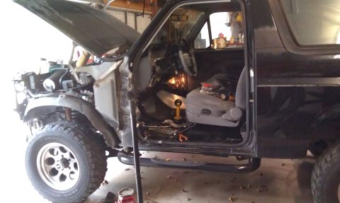 1995 Ford Bronco - Interior and engine bay of a 1995 Ford Bronco undergoing repairs.