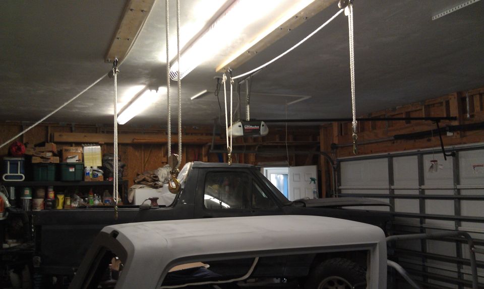 Dark truck cab and white hood in garage