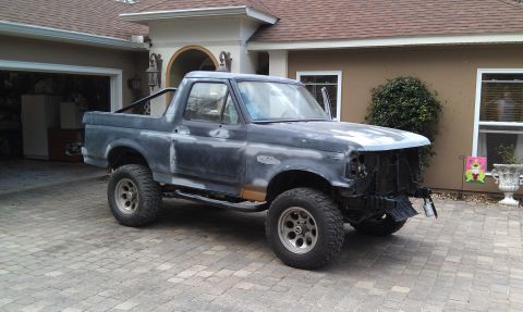 1995 Ford Bronco - This 1995 Ford Bronco is undergoing restoration, with its front end disassembled and the body in primer.