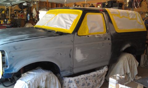 1995 Ford Bronco - Ford Bronco body undergoing preparation for a new paint job in a garage setting.