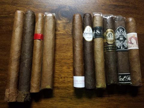 2018 Ford Bronco - A collection of cigars, some with distinctive bands, are laid out on a wooden surface.