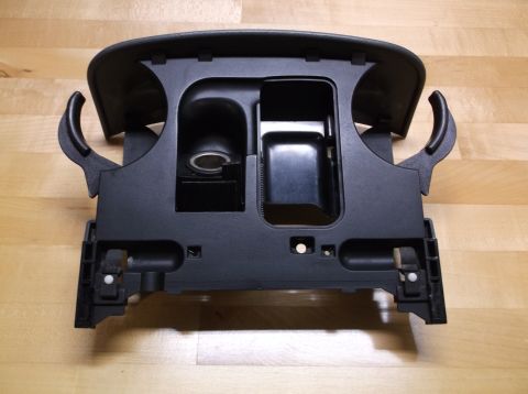 1995 Mercury Grand Marquis - This black center console assembly includes an ashtray, cup holder, and cigarette lighter socket, likely from a sedan.