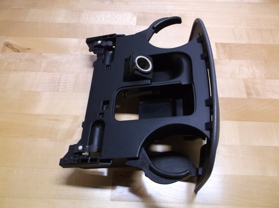 Black plastic car interior cup holder assembly with cigarette lighter socket