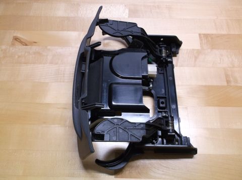 1995 Mercury Grand Marquis - This is a car interior part, possibly a cup holder assembly, shown on a wooden surface.