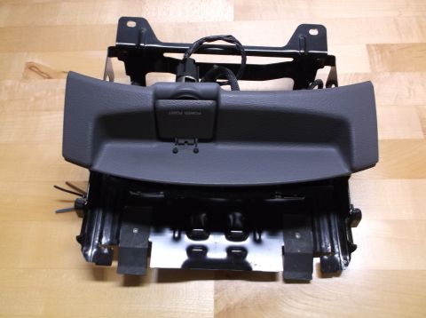 1995 Mercury Grand Marquis - This is a car interior part, possibly a console or dashboard component, with a power outlet.