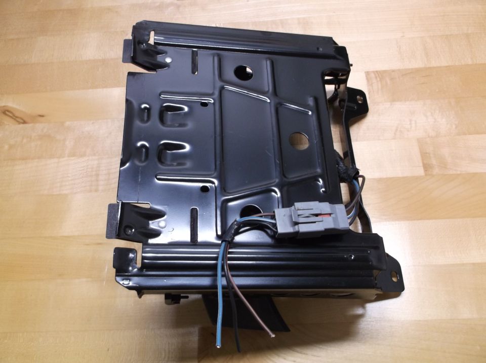Black metal car seat base frame with wiring harness and connector