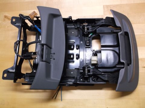 1995 Mercury Grand Marquis - This is a disassembled car interior part, likely a center console, showing its internal components and wiring.