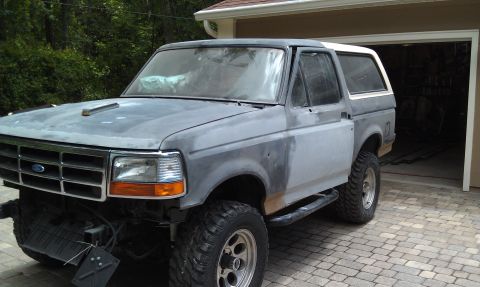 1995 Ford Bronco - This Ford Bronco appears to be undergoing bodywork, with its front bumper and grille removed.