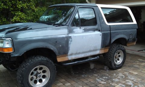 1995 Ford Bronco - This 1995 Ford Bronco is undergoing bodywork, with primer and filler applied to the front fender and door.