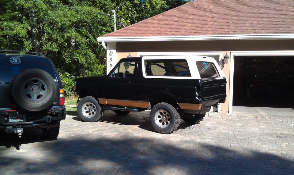 Black and white 1995 Ford Bronco parked in driveway