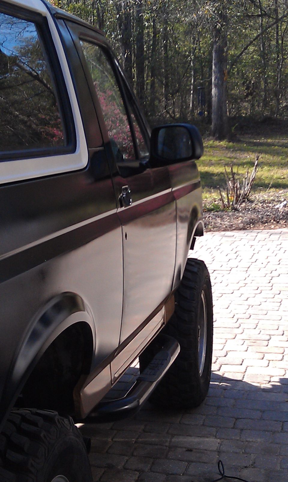 1995 Ford Bronco side profile with aftermarket running boards and large tires
