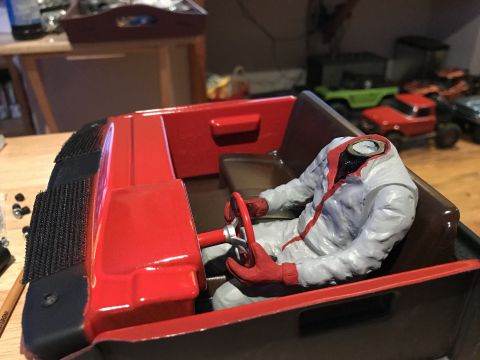 1989 Ford Bronco - A model car interior is shown with a headless figure seated at the steering wheel.