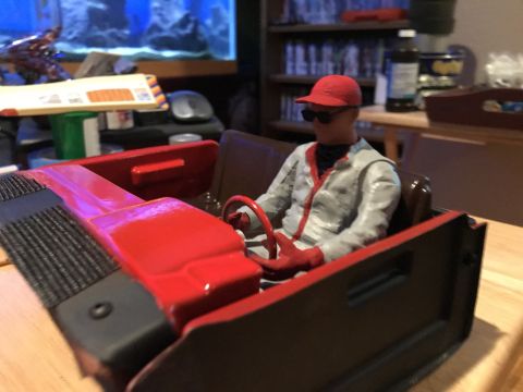 1989 Ford Bronco - A toy race car with a driver figure is on display.