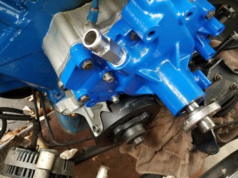 1976 Ford Ranchero - Close-up view of a freshly painted blue engine water pump, showing timing marks on the pulley.