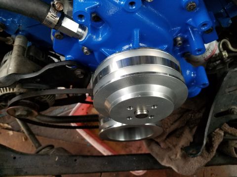 1976 Ford Ranchero - Close-up view of a polished aluminum water pump pulley attached to a blue engine block.