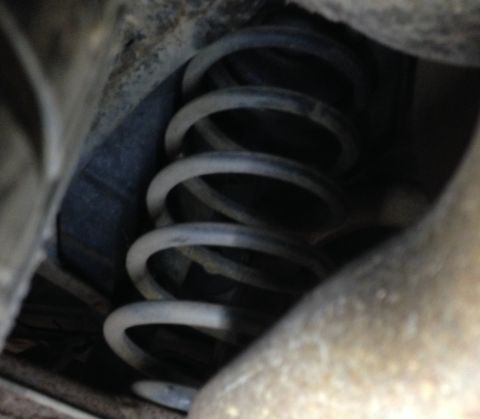 1988 Ford Crown Victoria LTD - A close-up view of a vehicle's coil spring, with visible text from Supermotors.net.