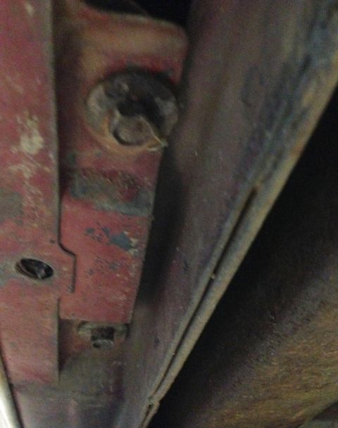 1988 Ford Crown Victoria LTD - Detail of a corroded metal bracket and fastener, likely from undercarriage.