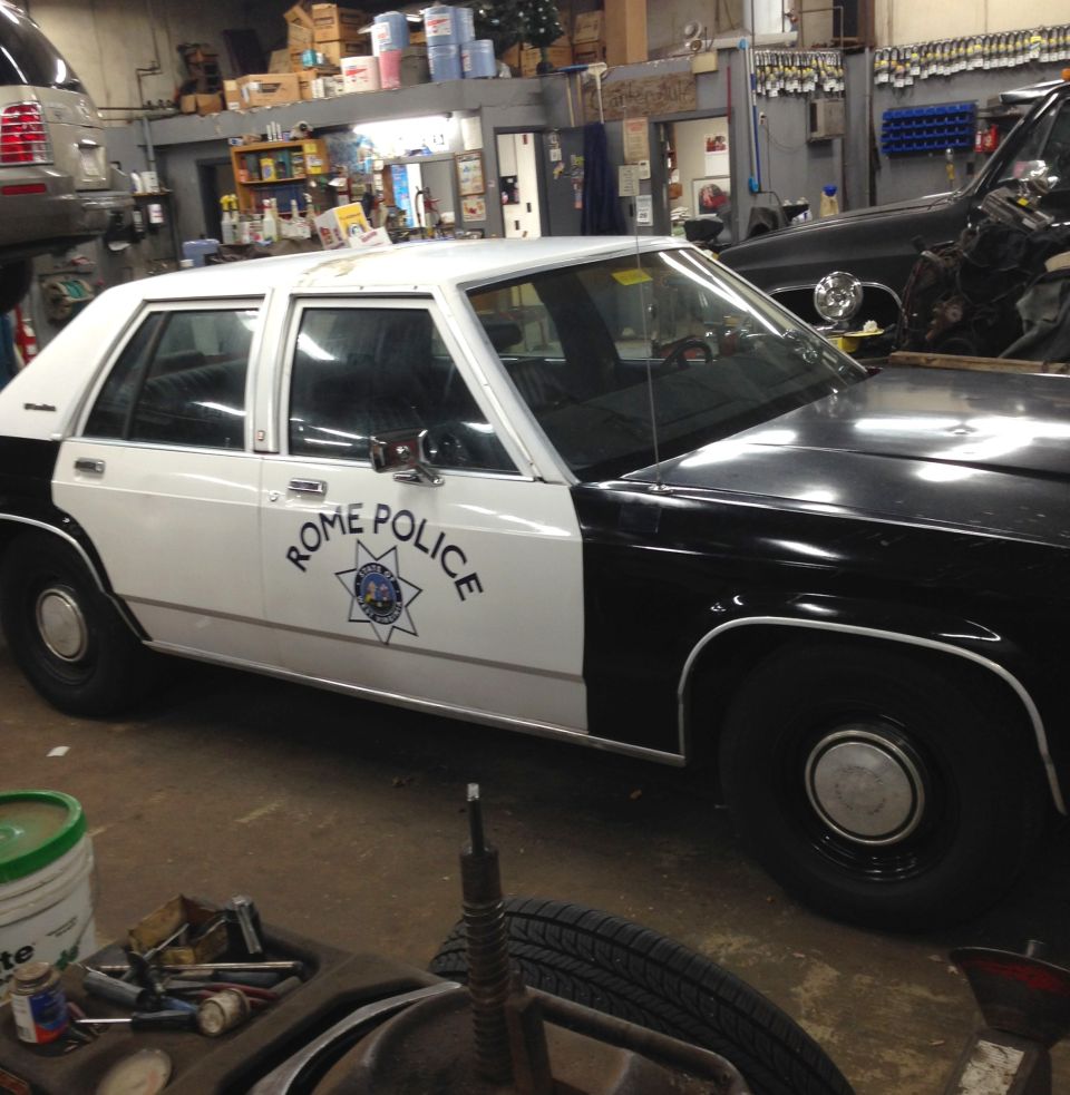 1988 Ford Crown Victoria LTD police car with 'ROME POLICE' text on the door