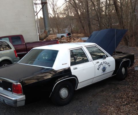 1988 Ford Crown Victoria LTD - This police car has 'Rome Police' written on its side. The hood is open, revealing the engine compartment.