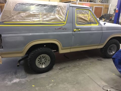 1985 Ford Bronco - This 1985 Ford Bronco is being prepped for rust repair, with its windows and trim taped off.
