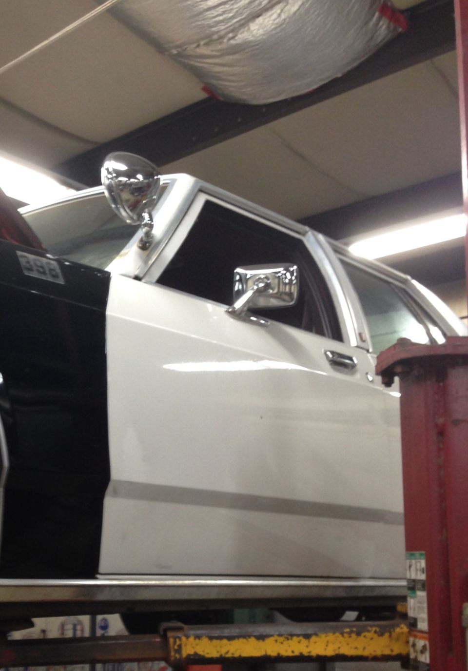 1988 Ford Crown Victoria LTD police car side view, two-tone black and white paint, spotlight on A-pillar
